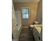 Neutral bathroom features a tub-shower, single vanity, and wood-look flooring at 2204 Liberty Sw Ln, Conyers, GA 30094