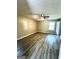 Neutral bedroom with wood-look flooring, ceiling fan, and natural light at 2204 Liberty Sw Ln, Conyers, GA 30094