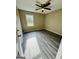Cozy bedroom featuring neutral walls, modern ceiling fan, and attractive wood-look flooring at 2204 Liberty Sw Ln, Conyers, GA 30094