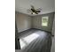 Well-lit bedroom with wood-look flooring, ceiling fan, and a large window at 2204 Liberty Sw Ln, Conyers, GA 30094