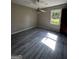 Bedroom featuring a ceiling fan, bright window, and modern vinyl flooring at 2204 Liberty Sw Ln, Conyers, GA 30094