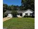 Charming single-story home with a well-maintained lawn and mature trees at 2204 Liberty Sw Ln, Conyers, GA 30094