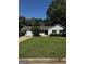 Charming single-story house with a well-maintained lawn, green shrubs, and front porch at 2204 Liberty Sw Ln, Conyers, GA 30094