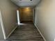 Hallway with gray flooring and access to multiple rooms at 2204 Liberty Sw Ln, Conyers, GA 30094