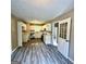 Well-lit kitchen featuring white cabinets, neutral countertops, backsplash and gray flooring at 2204 Liberty Sw Ln, Conyers, GA 30094
