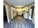 Charming kitchen featuring white cabinetry, a stainless steel dishwasher, and gray flooring at 2204 Liberty Sw Ln, Conyers, GA 30094