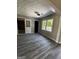 Bright living room showcasing vinyl floors, large windows, and multiple entryways at 2204 Liberty Sw Ln, Conyers, GA 30094