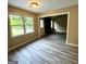 Bright living room featuring new gray flooring, light neutral walls and abundant natural light at 2204 Liberty Sw Ln, Conyers, GA 30094