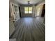 Bright living room showcasing vinyl floors, multiple windows, and classic doors at 2204 Liberty Sw Ln, Conyers, GA 30094