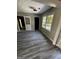 Bright living room showcasing vinyl floors, and a large window with natural light at 2204 Liberty Sw Ln, Conyers, GA 30094