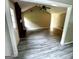 Open living room showcasing vaulted ceilings, a brick fireplace, and stylish gray flooring at 2204 Liberty Sw Ln, Conyers, GA 30094