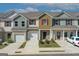 Lovely exterior view of townhomes with garages, brick facade, and inviting landscaping at 8714 Lakeview Commons # 48, Jonesboro, GA 30238