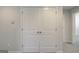 Hallway view of double doors and a glimpse into a carpeted room beyond at 8714 Lakeview Commons # 48, Jonesboro, GA 30238