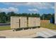 A cluster of beige mailboxes on a concrete pad with a view of trees and a clear blue sky in the background at 8714 Lakeview Commons # 48, Jonesboro, GA 30238