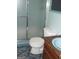 Bathroom with a toilet, shower, and small sink at 7225 Pineneedle Sw Dr, Covington, GA 30014