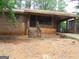 Traditional brick home with covered entry, front porch and a yard filled with pine needles at 7225 Pineneedle Sw Dr, Covington, GA 30014