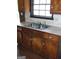 Kitchen features wooden cabinetry, double sink and window at 7225 Pineneedle Sw Dr, Covington, GA 30014