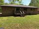 The backyard featuring a small deck and lush green grass at 9176 Carr Sw Cir, Covington, GA 30014