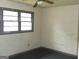 A bedroom with a neutral color scheme, a ceiling fan, and natural light from the window at 9176 Carr Sw Cir, Covington, GA 30014