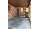 Open carport area with brick walls, an entrance door, and natural light at 9176 Carr Sw Cir, Covington, GA 30014