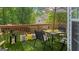 Back porch with a view into the woods, set with a table and chairs under a shady umbrella at 1401 Aberdeen Ct, Mcdonough, GA 30253