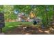 Expansive backyard surrounded by trees, offering a private outdoor space with a deck and recreational area at 1401 Aberdeen Ct, Mcdonough, GA 30253
