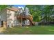 Large backyard with a deck, space for recreation, and lush greenery, creating an inviting outdoor space at 1401 Aberdeen Ct, Mcdonough, GA 30253