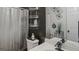 Well-lit bathroom featuring marble countertop vanity and practical storage solutions at 1401 Aberdeen Ct, Mcdonough, GA 30253
