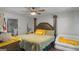 Bedroom featuring a large bed, ceiling fan, and view into the bathroom at 1401 Aberdeen Ct, Mcdonough, GA 30253