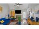 Bright living room showcasing a fireplace, television, and vibrant blue and gold furniture at 1401 Aberdeen Ct, Mcdonough, GA 30253