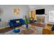 Bright living room featuring blue sofa, decorative fireplace, TV, and modern decor at 1401 Aberdeen Ct, Mcdonough, GA 30253