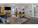 Cozy living room showcasing a fireplace, television, a blue couch and a gold couch with stylish decorations at 1401 Aberdeen Ct, Mcdonough, GA 30253