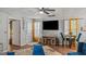 Cozy living room with a large TV, modern furniture, and natural light, perfect for relaxation at 1401 Aberdeen Ct, Mcdonough, GA 30253
