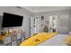This cozy main bedroom has a TV, walk-in closets, and a bright yellow throw over the bed at 1401 Aberdeen Ct, Mcdonough, GA 30253