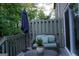 The outdoor deck has a wicker sofa, umbrella, and potted plants for a comfortable outdoor retreat at 2566 Summit Cove Dr, Duluth, GA 30097