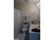Bright bathroom featuring a toilet, sink, and fluffy rug, plus neat storage for essentials at 2566 Summit Cove Dr, Duluth, GA 30097
