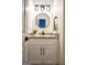 Modern bathroom vanity with granite countertop, black fixtures, oval mirror, and cabinet storage at 2566 Summit Cove Dr, Duluth, GA 30097