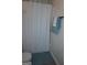 Bathroom showcasing a white shower curtain and a neatly arranged towel rack for convenience at 2566 Summit Cove Dr, Duluth, GA 30097