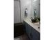 Bathroom featuring double sinks with elegant fixtures and a woven basket for storage at 2566 Summit Cove Dr, Duluth, GA 30097