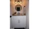 Stylish bathroom vanity with granite countertop, round mirror, and modern lighting fixture at 2566 Summit Cove Dr, Duluth, GA 30097
