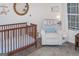Bedroom featuring a crib, rocking chair, and soft decor at 2566 Summit Cove Dr, Duluth, GA 30097