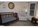 Lovely Bedroom features a cozy chair, a crib, and natural light creating a warm atmosphere at 2566 Summit Cove Dr, Duluth, GA 30097