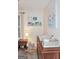 Bedroom featuring changing table, rocking horse, and open shelving with books at 2566 Summit Cove Dr, Duluth, GA 30097