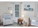 Charming Bedroom with rocking chair, wooden furniture, and soft lighting at 2566 Summit Cove Dr, Duluth, GA 30097