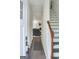 Inviting entryway with hardwood floors, staircase, and a view into the modernly furnished living room at 2566 Summit Cove Dr, Duluth, GA 30097