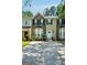 Charming townhouse featuring stone accents, a well-manicured lawn, and a private driveway at 2566 Summit Cove Dr, Duluth, GA 30097