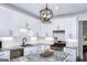 Modern kitchen with white cabinets, granite countertops, stainless steel appliances, and an island at 2566 Summit Cove Dr, Duluth, GA 30097