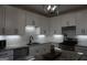Bright kitchen with granite counters, stainless steel appliances, and modern lighting at 2566 Summit Cove Dr, Duluth, GA 30097