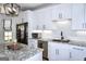 Well-appointed kitchen with granite countertops, stainless steel appliances, and a stylish light fixture at 2566 Summit Cove Dr, Duluth, GA 30097