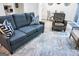 Spacious living room features a comfortable sofa, armchair, and a decorative area rug at 2566 Summit Cove Dr, Duluth, GA 30097